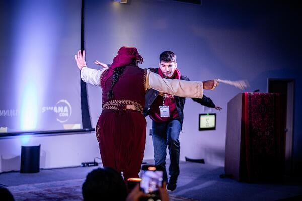 two people dancing on stage
